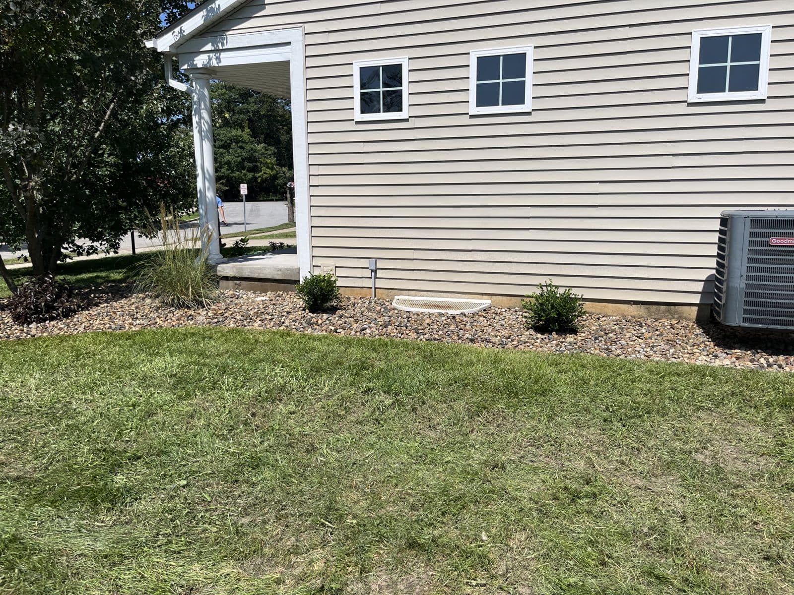 Foundation rock bed with fresh plantings by Meeks Mowing & Landscaping