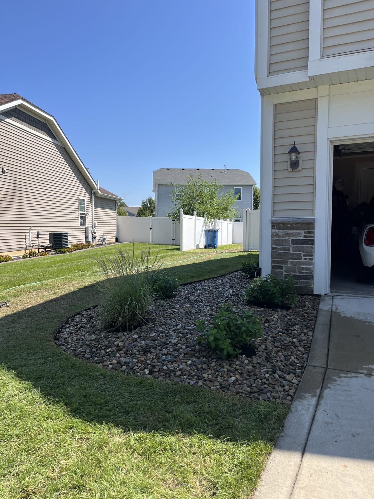 Curved rock bed with ornamental grasses